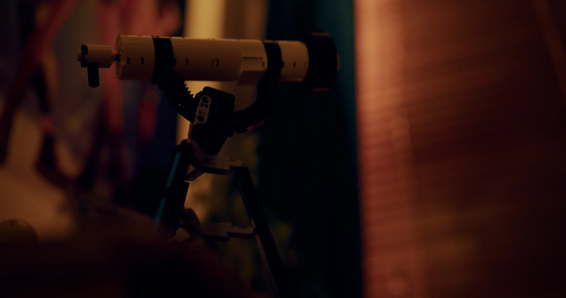 A small telescope in a warmly lit room